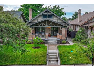 Charming craftsman home with a well-maintained lawn and inviting front porch at 549 N Ogden St, Denver, CO 80218