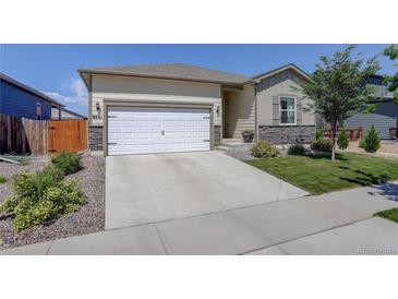 Charming single-Gathering home featuring a two-car garage, well-kept lawn, and inviting curb appeal at 8861 Ventura St, Commerce City, CO 80022