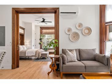 Cozy living room featuring wood trim, hardwood floors, and stylish decor at 1763 N Williams St # 101, Denver, CO 80218