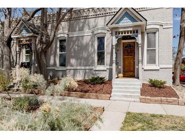 Charming home exterior with a well-kept front yard, beautiful front door, and classic architectural details at 2841 W 27Th Ave, Denver, CO 80211