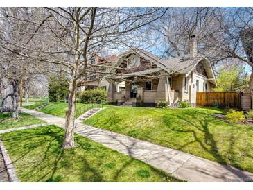 Charming brick home featuring well-manicured lawn and mature tree, creating lovely curb appeal at 780 N Franklin St, Denver, CO 80218