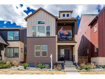 Charming two-story home featuring a covered balcony with an American flag and manicured front yard at 16762 Tejon Ln, Broomfield, CO 80023