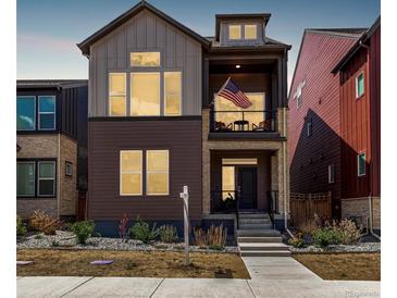 Two-story home with mixed siding, covered porch, and a walkway to the front door at 16762 Tejon Ln, Broomfield, CO 80023