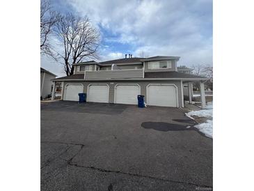 Exterior view of a townhome building with four garages at 12652 E Warren Dr # C, Aurora, CO 80014