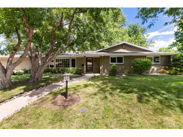 Charming single-story home with a well-maintained lawn, mature trees, and a welcoming walkway at 2934 S Columbine St, Denver, CO 80210
