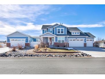 Charming two-story home with a three-car garage, and professionally landscaped front yard at 3385 Birch Rd, Longmont, CO 80504