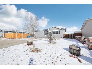 Charming home features new siding, mature landscaping, and inviting curb appeal on a sunny day at 262 Apache Pl, Brighton, CO 80603