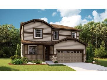 Charming two-story home featuring a two-car garage, covered porch, and a beautifully landscaped front yard at 1312 Sienna Peak Cir, Erie, CO 80516