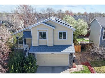 Charming two-story home featuring a two-car garage and a well-maintained front yard at 11836 Columbine St, Thornton, CO 80233