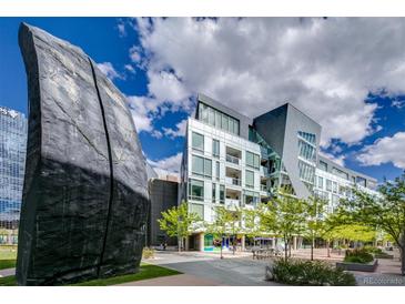 Modern building with unique architectural design and green landscaping at 55 W 12Th Ave # 211, Denver, CO 80204