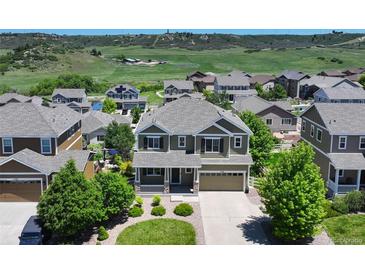 Stunning two-story home with a well-manicured front yard and a scenic view of rolling hills at 5528 Echo Hollow St, Castle Rock, CO 80104