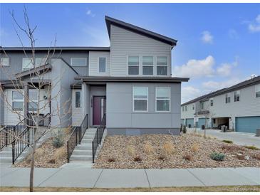 Modern two-story home with gray siding, stylish landscaping, and a welcoming front entrance at 18938 E 64Th Pl, Denver, CO 80249