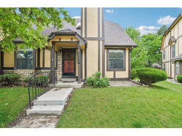 Charming home with a well-manicured lawn and neutral-colored facade with stone and brown accents at 18538 E Whitaker Cir # A, Aurora, CO 80015