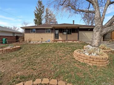 Charming brick and wood home featuring a manicured lawn and mature landscaping at 13477 E Center Ave, Aurora, CO 80012