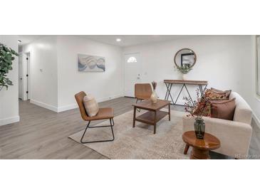 Bright living room with hardwood floors, modern furnishings, and stylish decor at 1326 Sable Blvd, Aurora, CO 80011