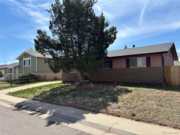 Charming single-story home with a mature tree in the front yard at 14832 Elmendorf Pl, Denver, CO 80239