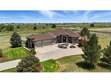 Stunning ranch style home with a three car garage, fountain and circular driveway at 31200 E 145Th Ave, Brighton, CO 80603