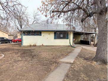 Charming single story home with a covered parking area and mature trees in the front yard at 2696 S Grove St, Denver, CO 80219