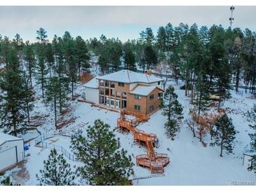 Spacious home on wooded lot with expansive decks and multiple levels at 757 N Bluff Dr, Franktown, CO 80116