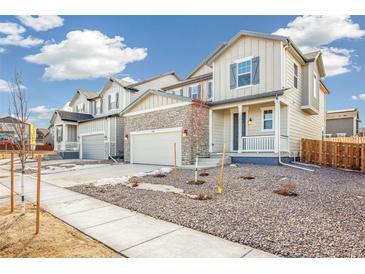 Two-story house with stone accents and a front porch at 13432 E 110Th Way, Commerce City, CO 80022