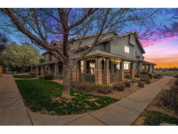 Charming townhome exterior showcasing the inviting porch and landscaped front yard at 2900 Purcell St # F1, Brighton, CO 80601