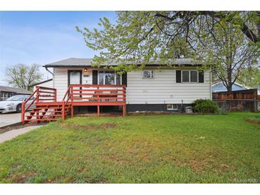 Charming single-story home featuring a red front porch and well-maintained lawn in a residential neighborhood at 6267 Fenton St, Arvada, CO 80003