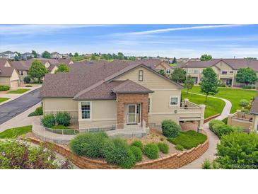 Inviting single-story home with landscaped front yard and stone accents, offering accessibility with a convenient ramp at 22124 E Euclid Dr, Aurora, CO 80016