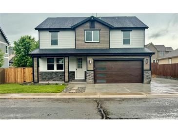 Two-story home with modern design elements, including a multi-tone exterior and contemporary garage door at 5550 Wetlands Dr, Longmont, CO 80504