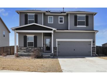 Charming two-story home with gray siding, black shutters, covered porch, and attached two-car garage in a quiet neighborhood at 7131 Shavano Cir, Frederick, CO 80504