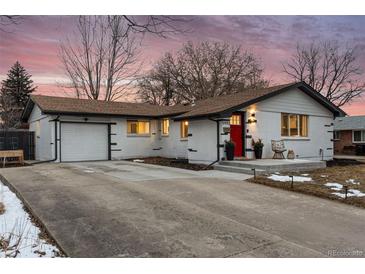 Charming ranch-style home featuring a painted brick exterior, well-kept lawn, and a cozy front porch at 5993 Field St, Arvada, CO 80004