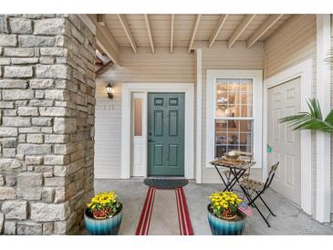 Inviting front entrance with stone accents, stylish door, and charming outdoor seating area at 4085 S Crystal Cir # 101, Aurora, CO 80014