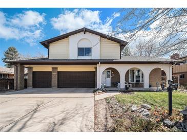 Charming two-story home featuring a two-car garage, front porch arches, and well-maintained landscaping at 1482 S Lansing St, Aurora, CO 80012