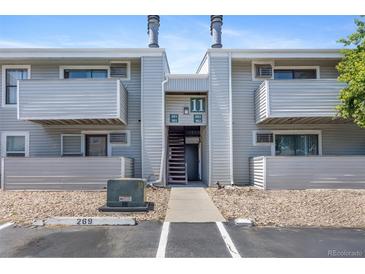 Apartment building exterior with gray siding, balconies, and an open stairway at 10150 E Virginia Ave # 11-202, Denver, CO 80247