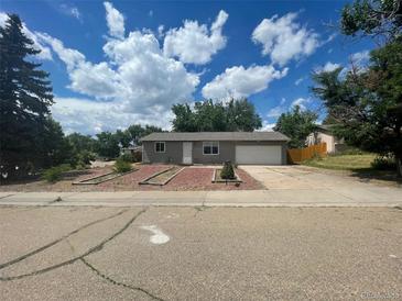 Ranch style home with attached garage and landscaped yard at 15821 E Bates Pl, Aurora, CO 80013