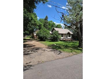 Charming single-Gathering home with mature trees, a gravel driveway and classic architectural details at 2350 / 2352 Garland St, Lakewood, CO 80215