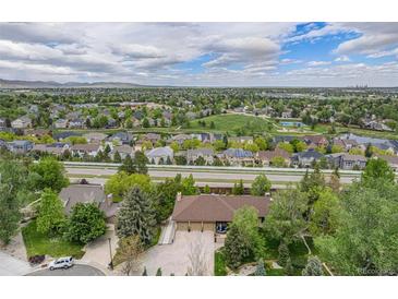 Expansive aerial view of the property showcasing the neighborhood and surrounding landscape with mountain views at 7522 S Mount Zirkel, Littleton, CO 80127
