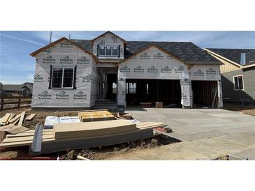 New construction two-story home featuring a two-car garage and covered porch awaiting its finishing touches at 16843 Ballinger Cir, Mead, CO 80542