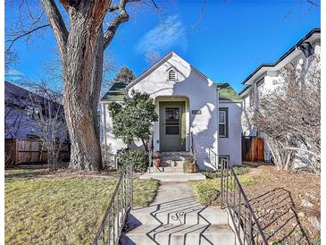 Charming stucco home with a green door and mature landscaping at 2339 S Adams St, Denver, CO 80210