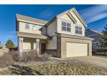 Charming two-story home boasts a lovely exterior with a well-manicured lawn and attached two car garage at 254 Ellendale St, Castle Rock, CO 80104