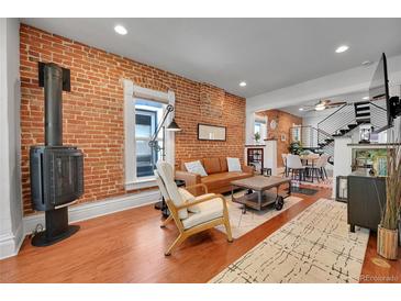 Bright living room with exposed brick wall and modern furniture at 1208 S Pennsylvania St, Denver, CO 80210