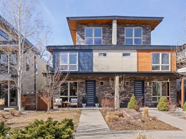 Modern townhome with stone and wood accents, featuring a well-manicured front yard and inviting entryway at 4529 Vrain St, Denver, CO 80212