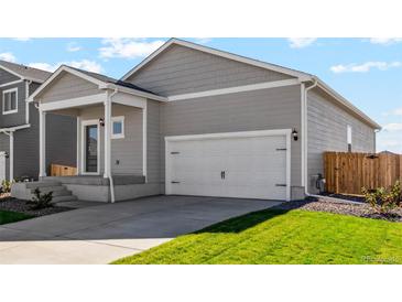 Charming home featuring a two-car garage, well-maintained lawn and covered front porch at 7208 Dolores Ave, Frederick, CO 80530