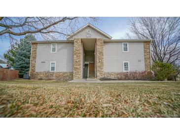 Inviting two-story condo building with stone accents and well-maintained landscaping at 7656 Depew St # 1802, Arvada, CO 80003