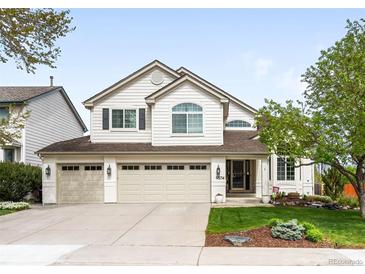 Charming two-story home with three-car garage and well-manicured lawn at 9574 Las Colinas Dr, Lone Tree, CO 80124