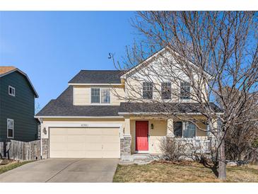 Inviting two-story home with red door, attached garage, and manicured lawn on a sunny day at 6184 Clayton St, Frederick, CO 80530