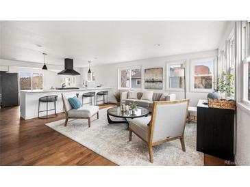 Bright, airy living room with modern decor, featuring hardwood floors and large windows for natural light at 11640 W 13Th Ave, Lakewood, CO 80401