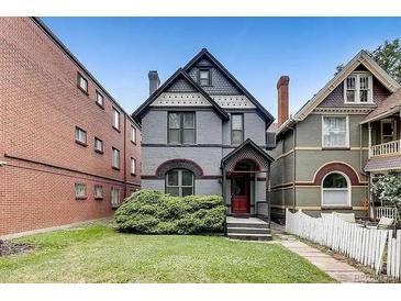Charming home with a well-manicured front lawn and inviting entrance, perfect for a Gathering at 1365 Clayton St, Denver, CO 80206