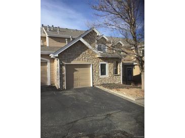 Attractive exterior of townhome with stone accents and a two-car garage at 2977 W 119Th Ave # 202, Westminster, CO 80234