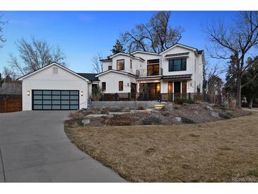 Striking modern farmhouse with large windows, black trim, and three-car garage on a professionally landscaped lot at 815 E Westglow Ln, Greenwood Village, CO 80121