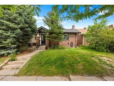 Charming brick home with lush green lawn and mature trees at 346 N Corona St, Denver, CO 80218